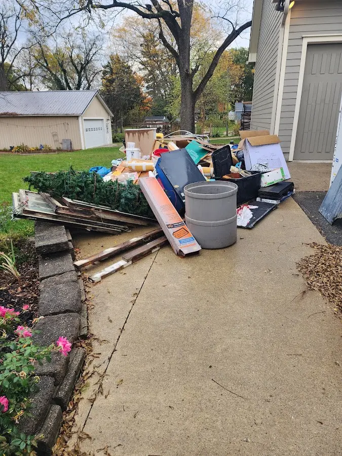 Dumpster being loaded with debris for Estate Cleanout Dumpster Rental in Lake Panasoffkee